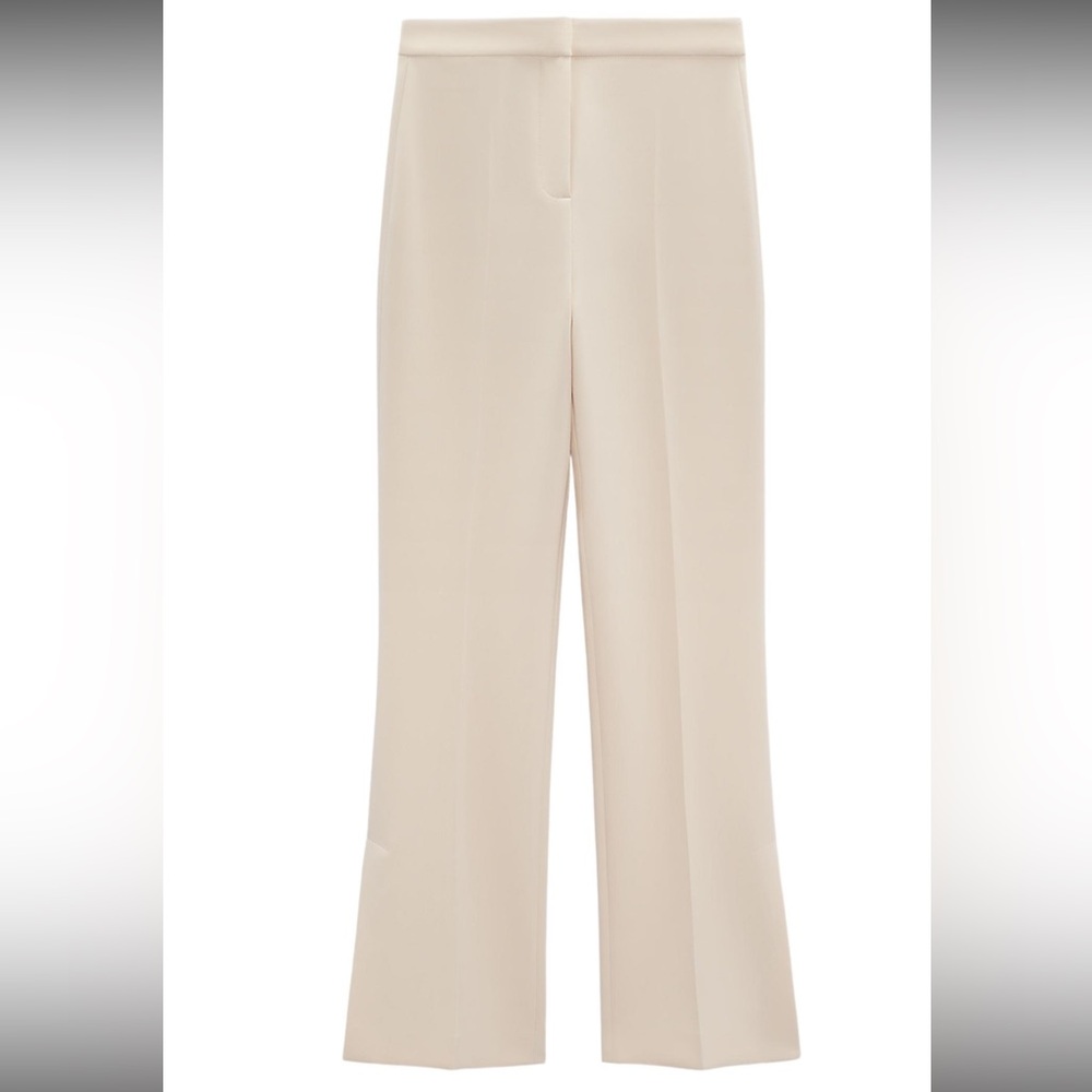 High-waisted pants with false back welt pockets.
